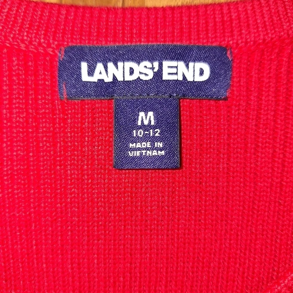 A Lands End cable knit sweater in a size medium 100% cotton.